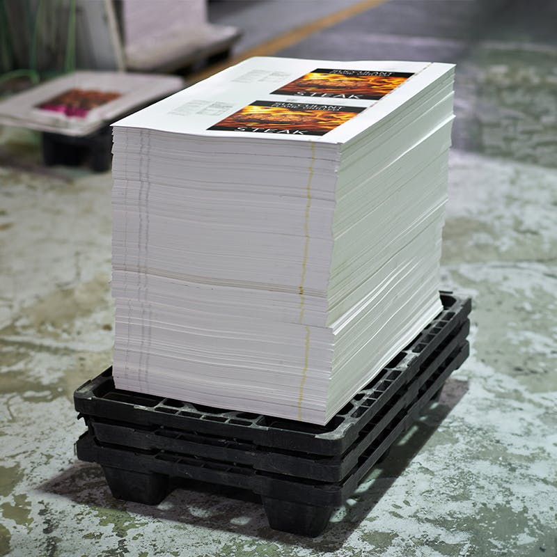 Stack of printed posters on a pallet 