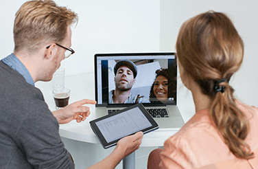man and woman on a video conference with another man and woman