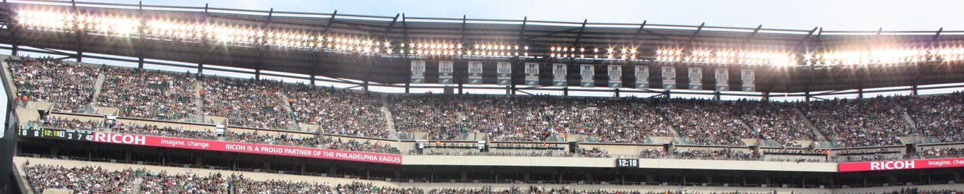 Photo of a stadium with lights and Ricoh displayed on the banner