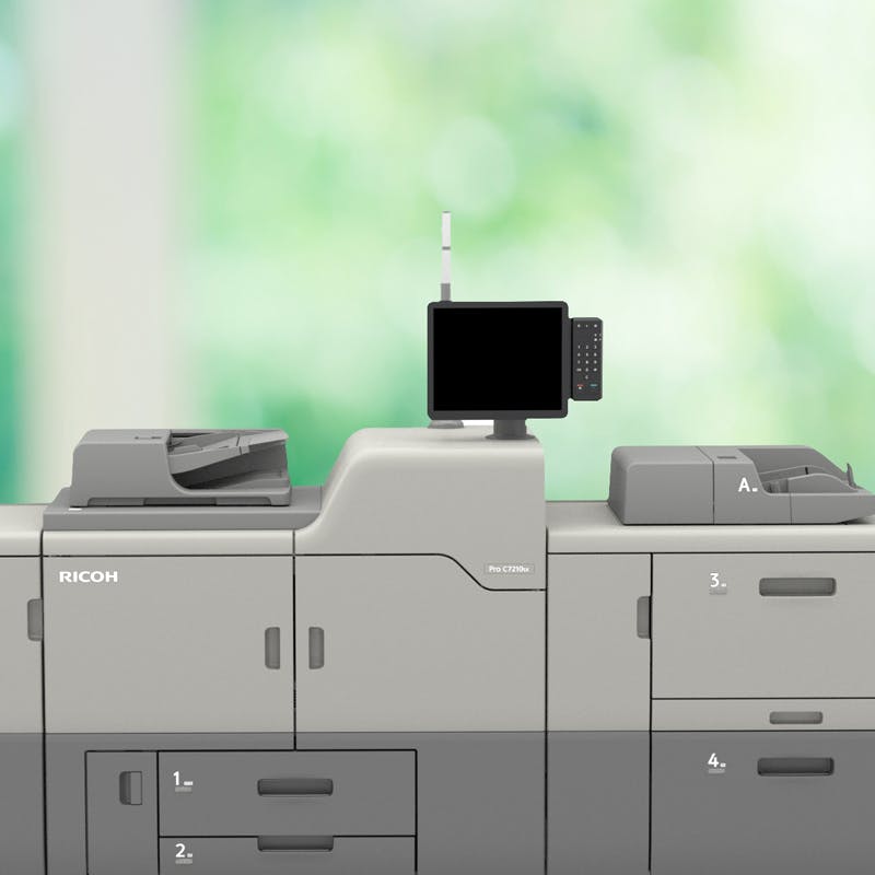 ricoh pro 7210sx printer in office with greenery outside windows in back