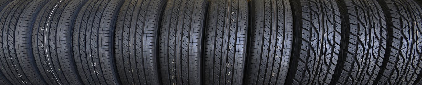 Group of new tires for sale at a tire store.