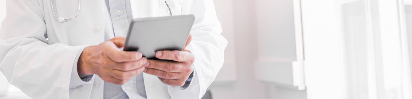 Doctor using tablet device