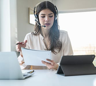 woman talking on headset working from home