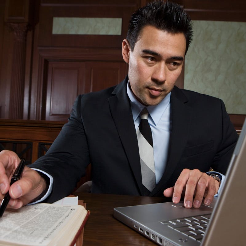 Man using laptop in court