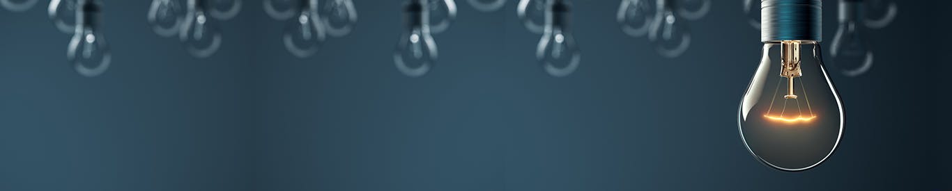 Series of lightbulbs in dark blue space