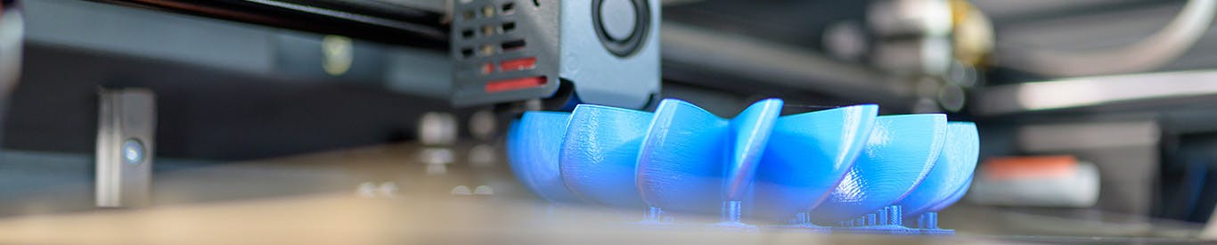 Blue 3D object being printed slightly out of focus