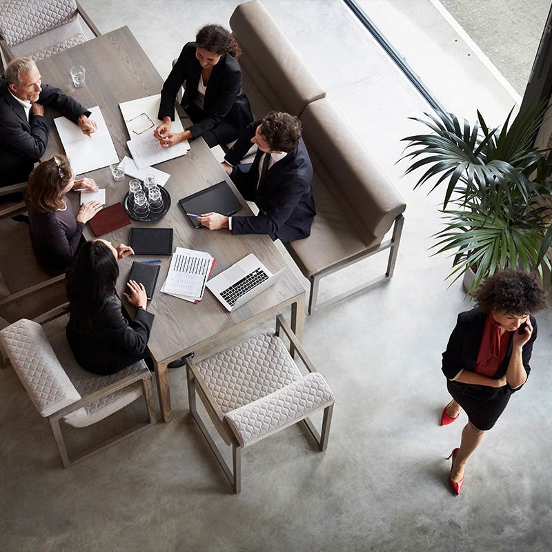 A group of business people around a meeting table