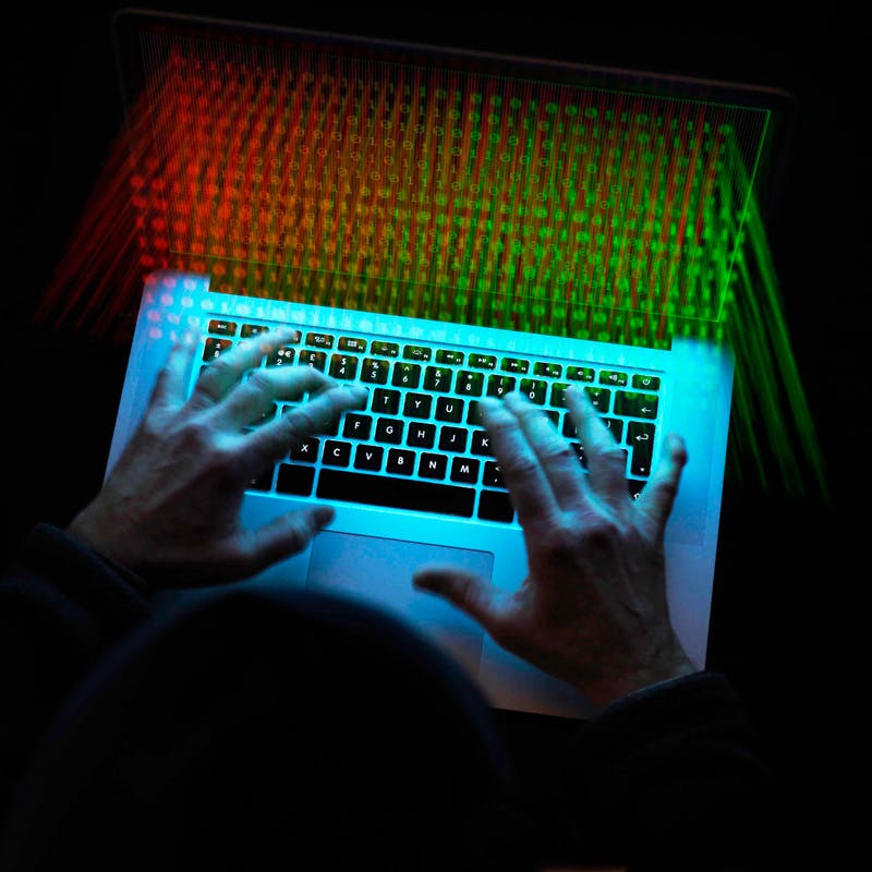 Hands typing on laptop, preventing cyber attack