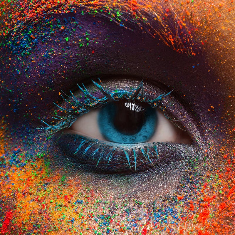 closeup facial shot of vivid colored powder on a face
