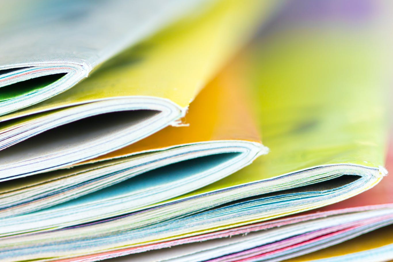 Close up edge of colorful magazine stacking.