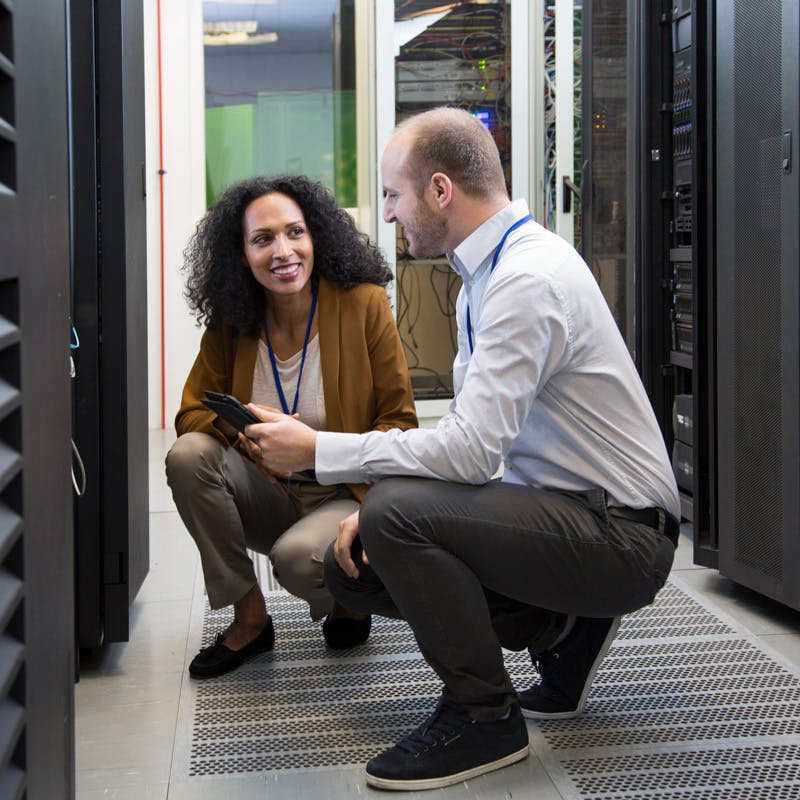 man and woman working in data center