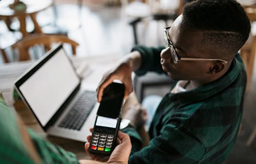 Man paying on a POS with his mobile phone