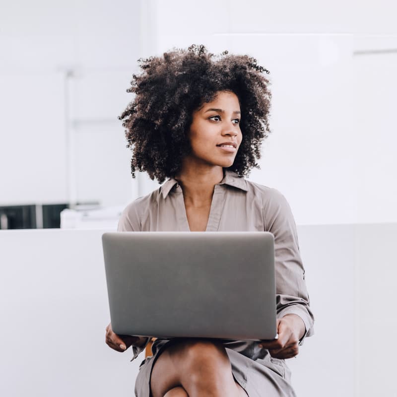 Woman sitting working on a laptop