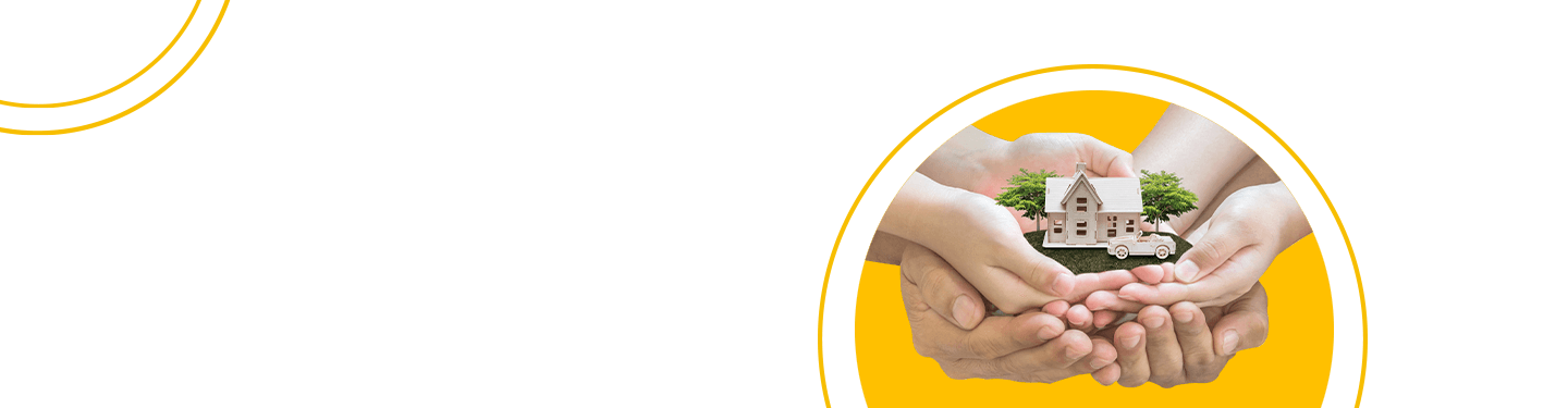 Hands holding wood replicas of a home and car