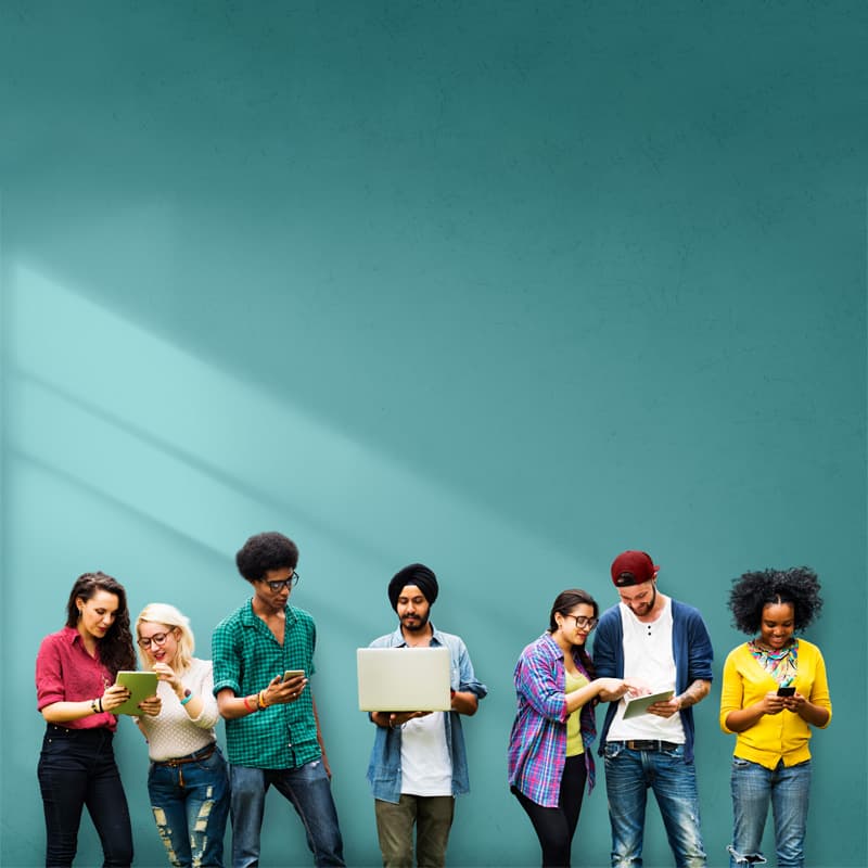 Group of people standing next to each other working on different technologies