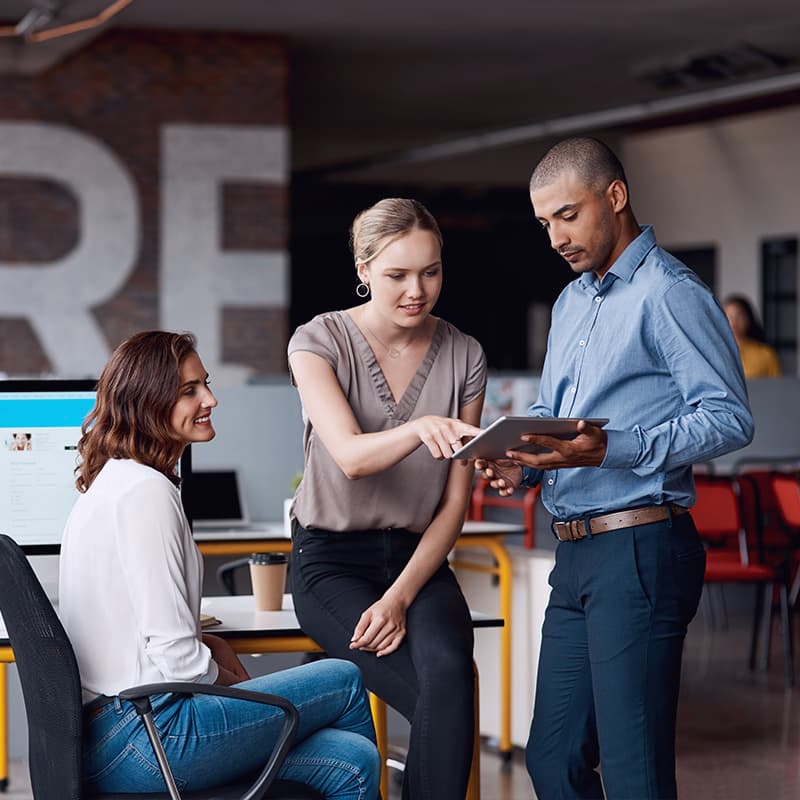 Shot of a group of businesspeople using a digital tablet together in an office