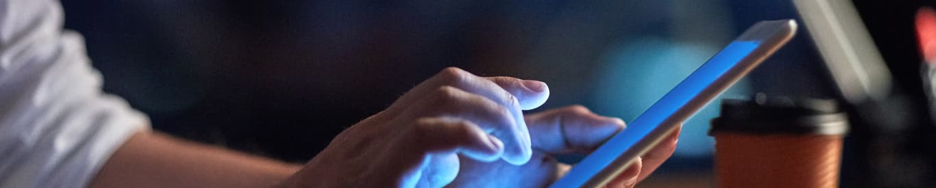 Businessman using a digital tablet at night in an office.