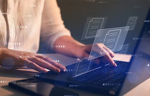 Woman working on laptop with advanced Intelligent Document Processing