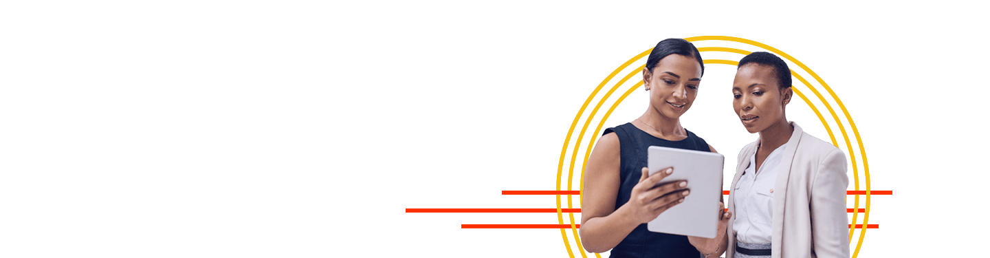 Two female coworkers looking at a tablet