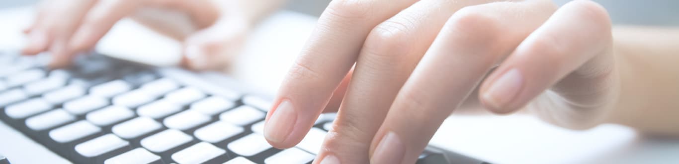 Ricoh close-up of woman typing on a keyboard