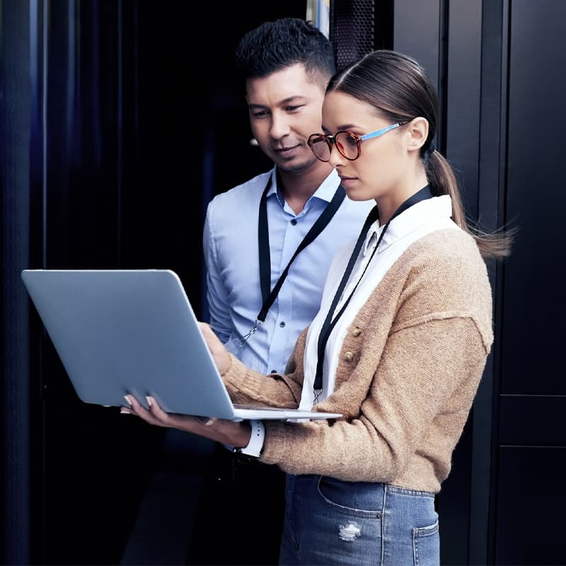 Two IT Techs looking at a laptop