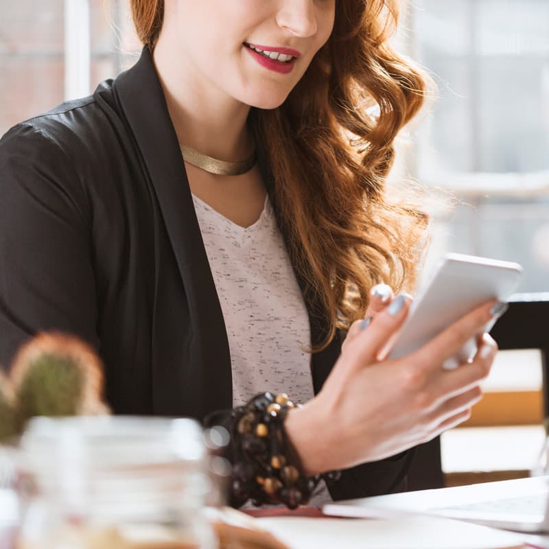 business woman working on laptop and mobile phone