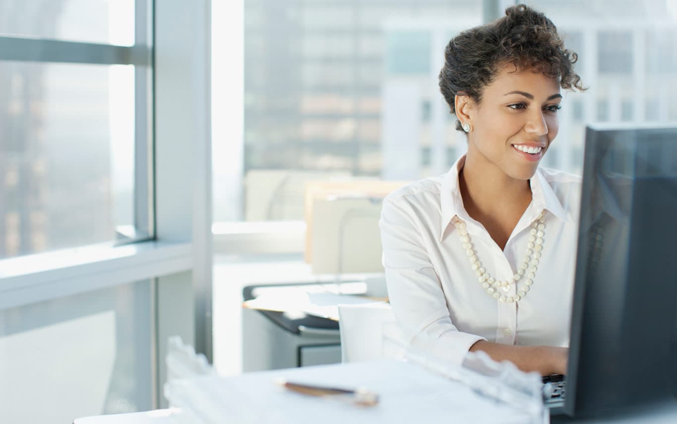 woman smiling at computer
