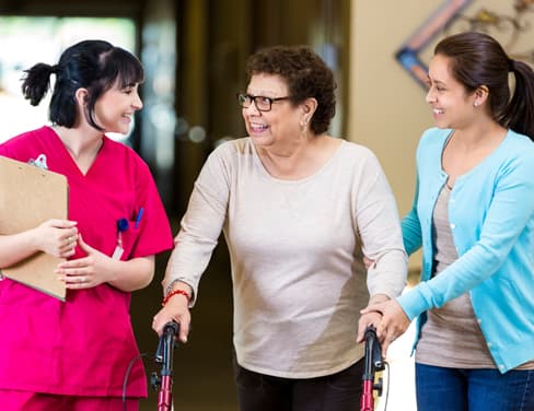 Caregiver and elderly woman with relative.