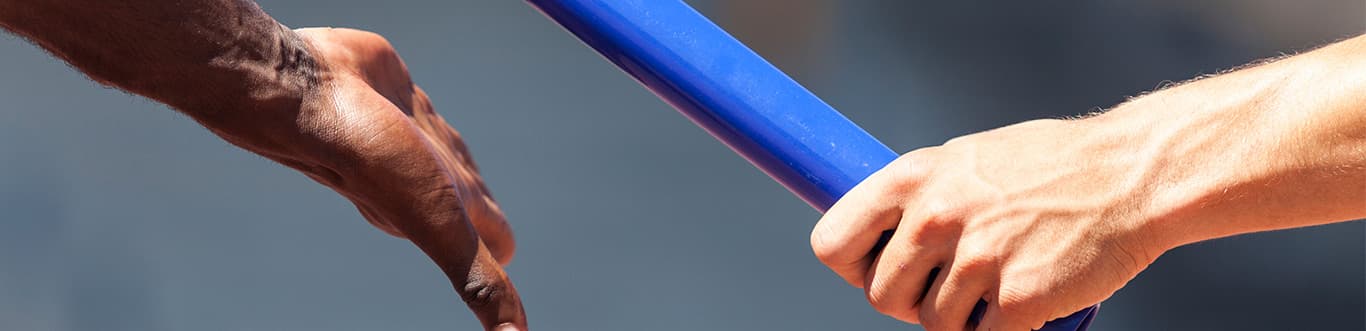 Image of a hand handing a baton to another hand