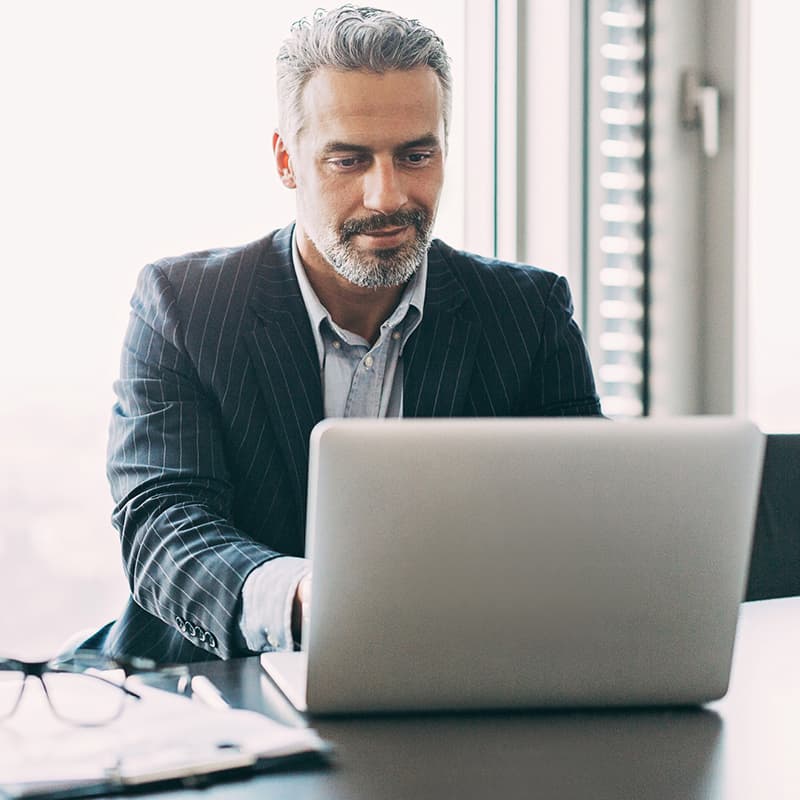 Smiling man working on desktop computer