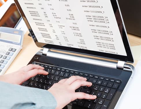 Ricoh above close-up view of person typing on laptop
