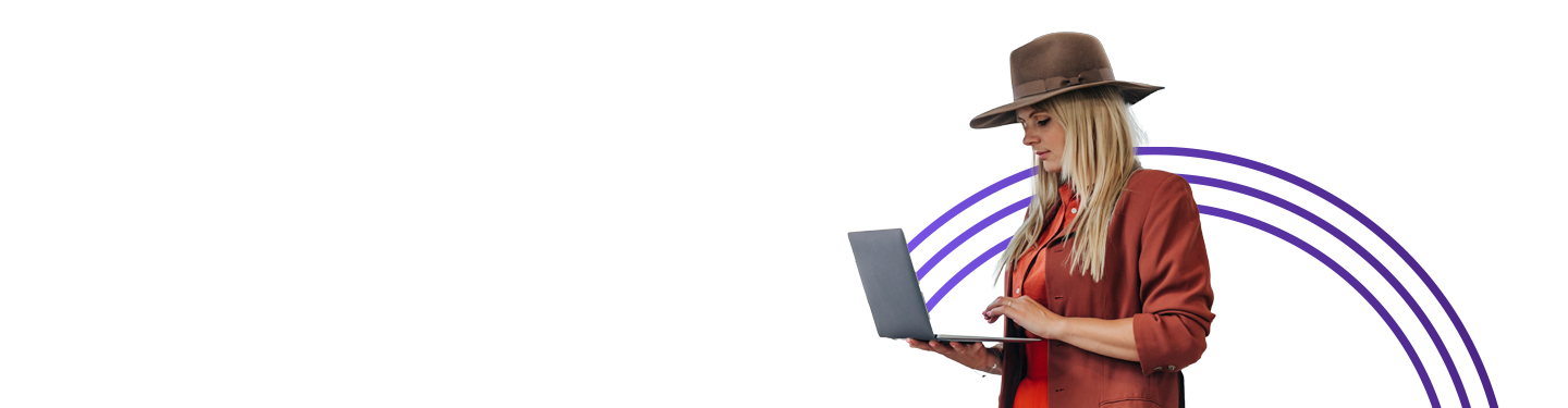 Woman standing working on a laptop