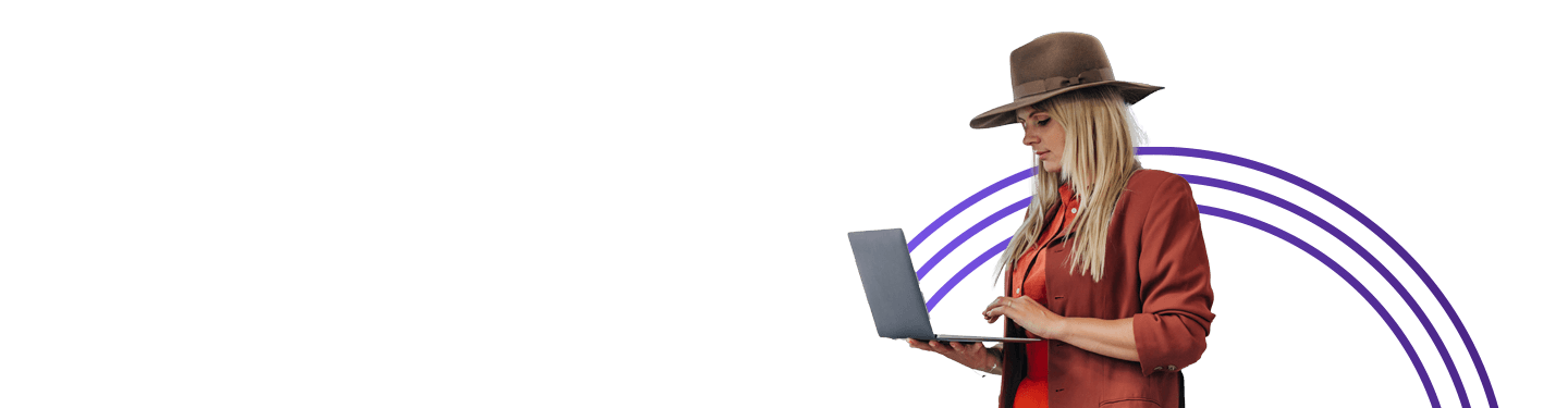 Woman standing working on a laptop
