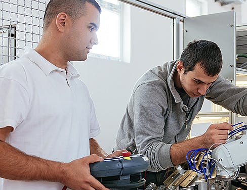 Two technicians working on a project