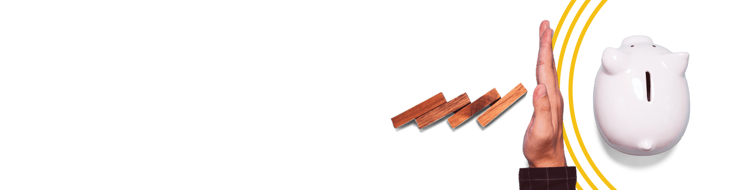 hand stopping wood blocks from knocking over piggy bank