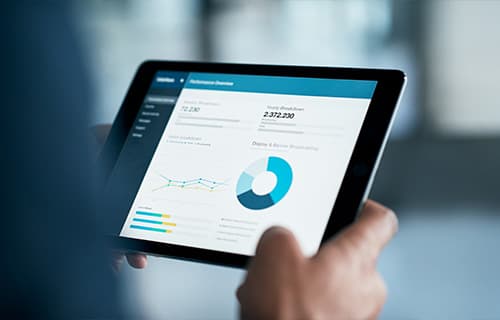 Closeup shot of a businessman analyzing statistics on a digital tablet in an office