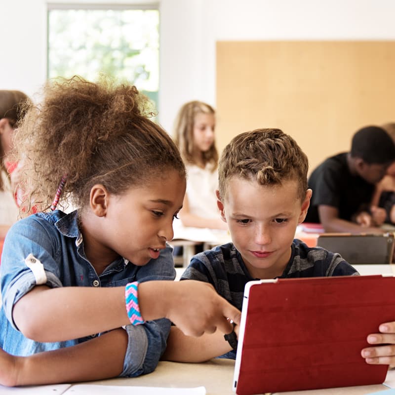 kids in class using tablets