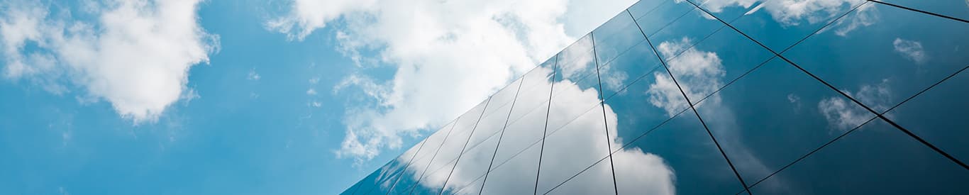 office building with reflection of clouds