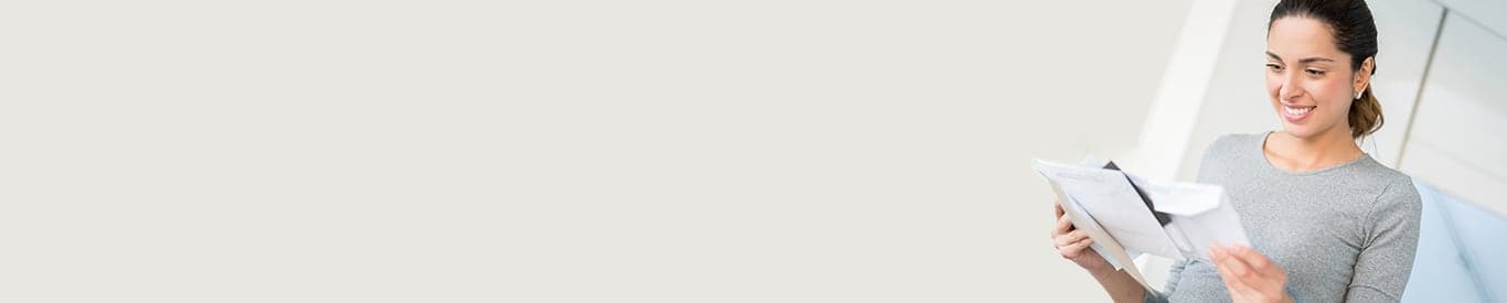 Woman holding stack of mail