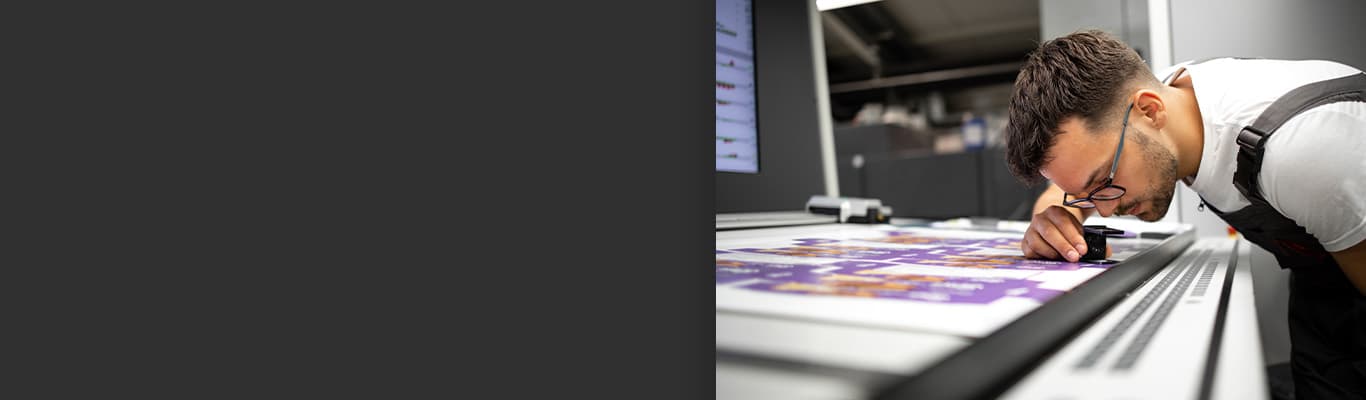worker doing a press check on recently printed document