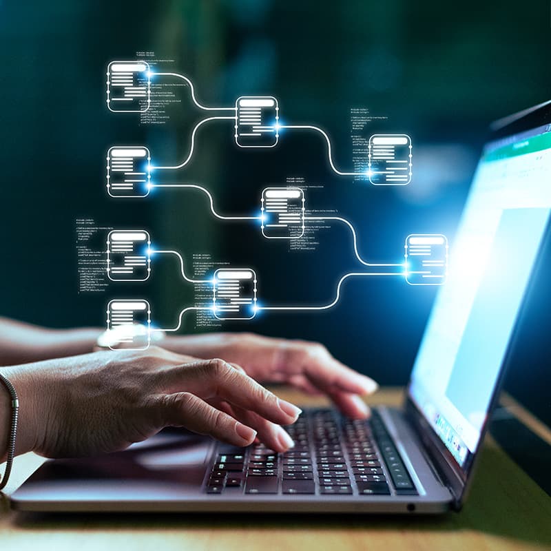Hands using keyboard on a laptop with digital wired data, demonstrating practices for the most rigorous industry standards.